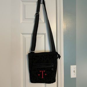 Black 31 purse with initial T inscribed in red.